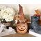 This image shows a Halloween witch decoration. It is made from a real dried gourd. Her name is Beatrice and has an orange witch hat.